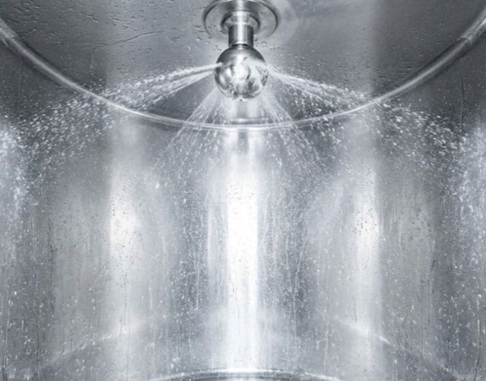 CIP cleaning with rotating spray head in stainless steel container